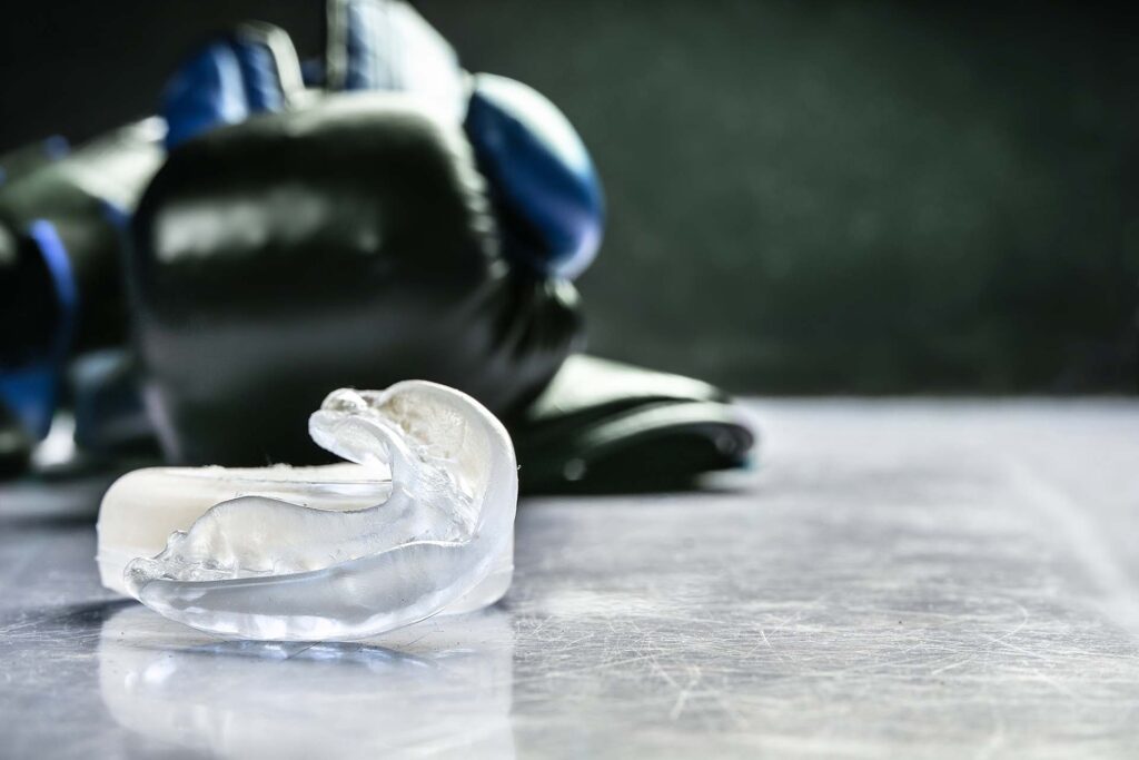 A mouthguard, emphasizing its importance for individuals with active lifestyles or those with braces or orthodontic treatments to protect their smiles during sports or an active lifestyle.