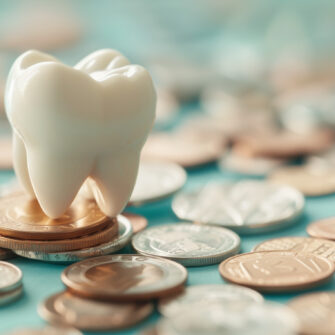 Tooth on coins, representing the payment options available for orthodontic patients.