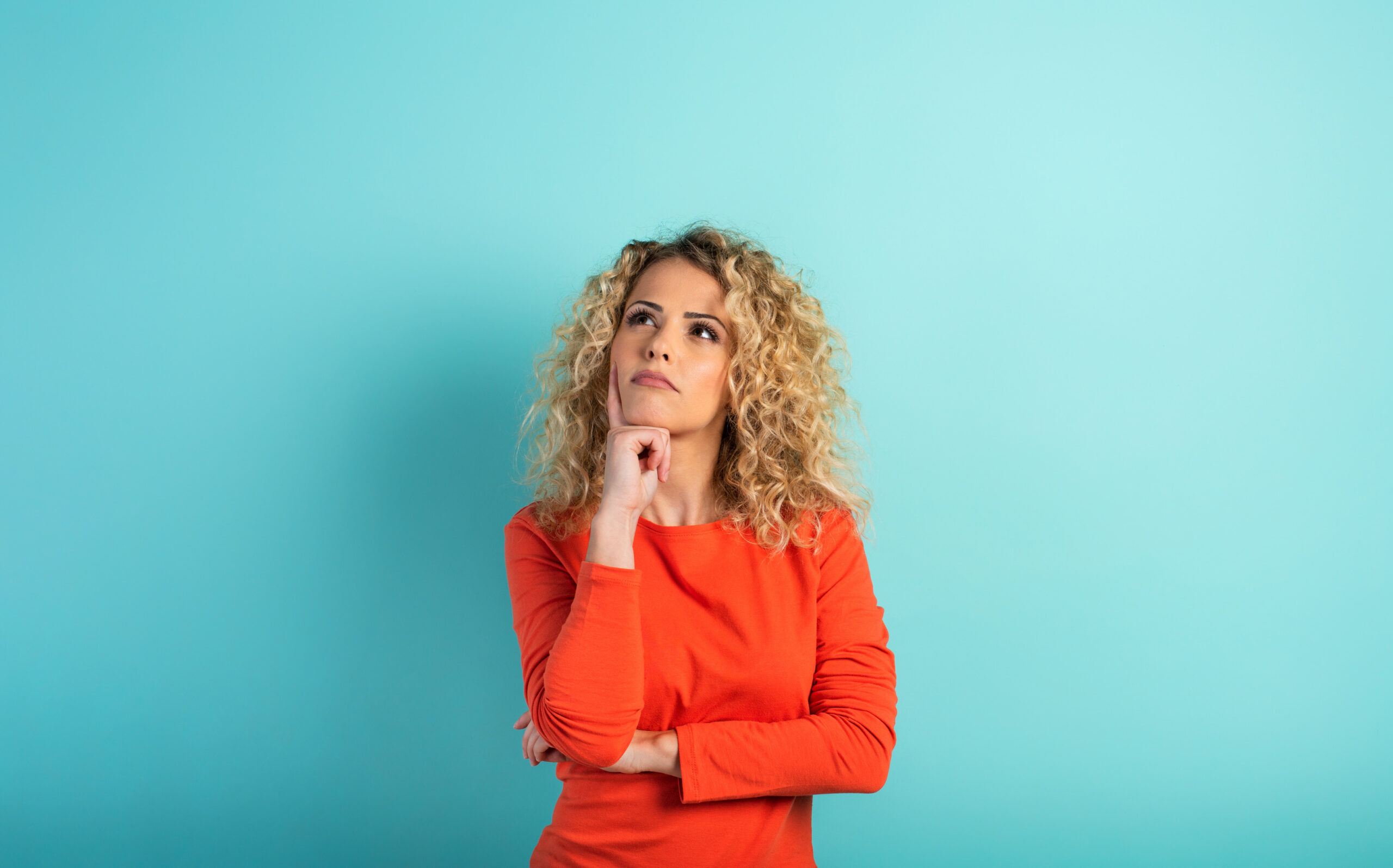 Woman looking up and pondering a question.