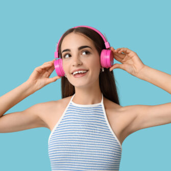 Girl smiling with a gap in her teeth, listening to music on headphones